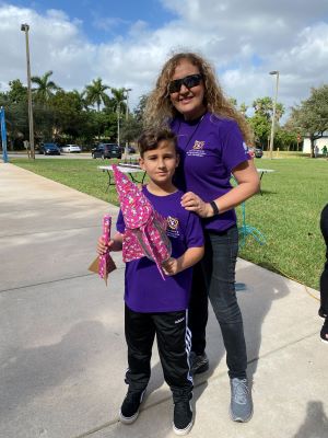 Dr. Chiarella poses with a student and model rockets