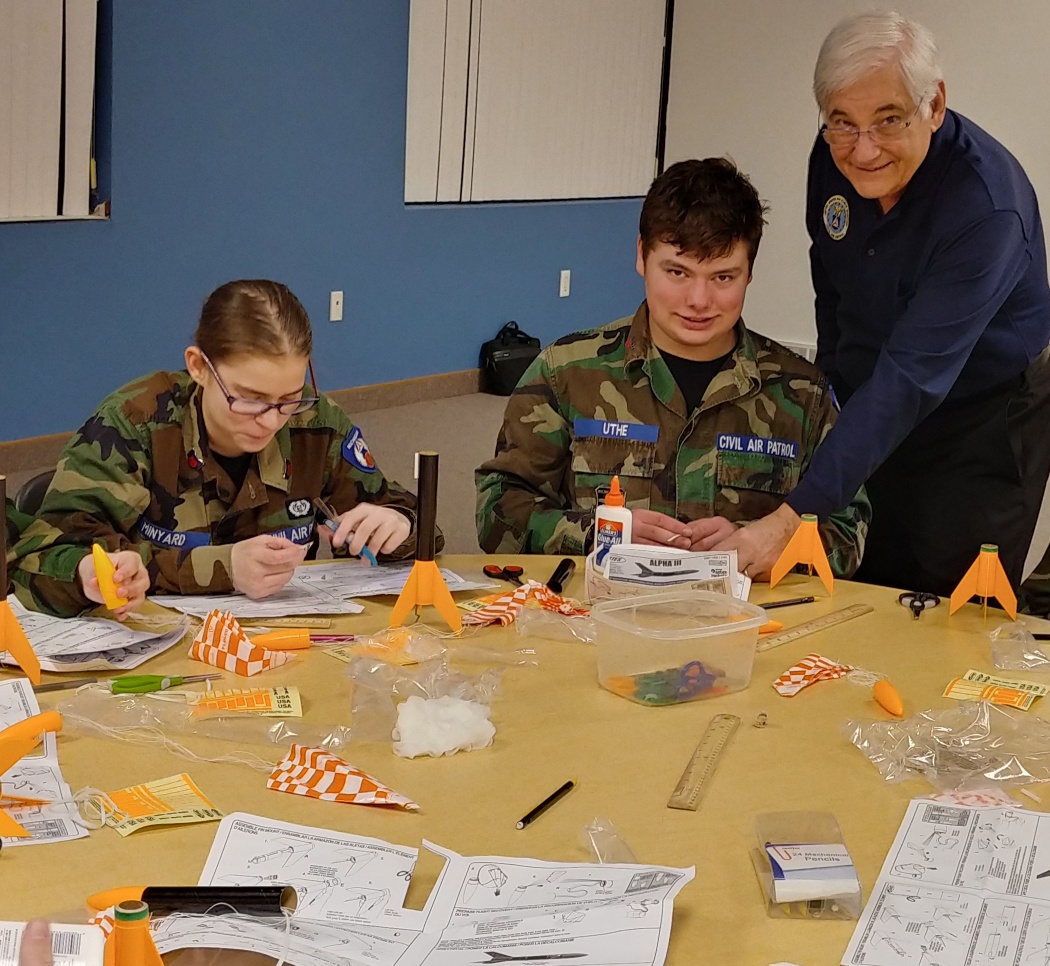Lt. Col. Roldan assists cadets building model rockets