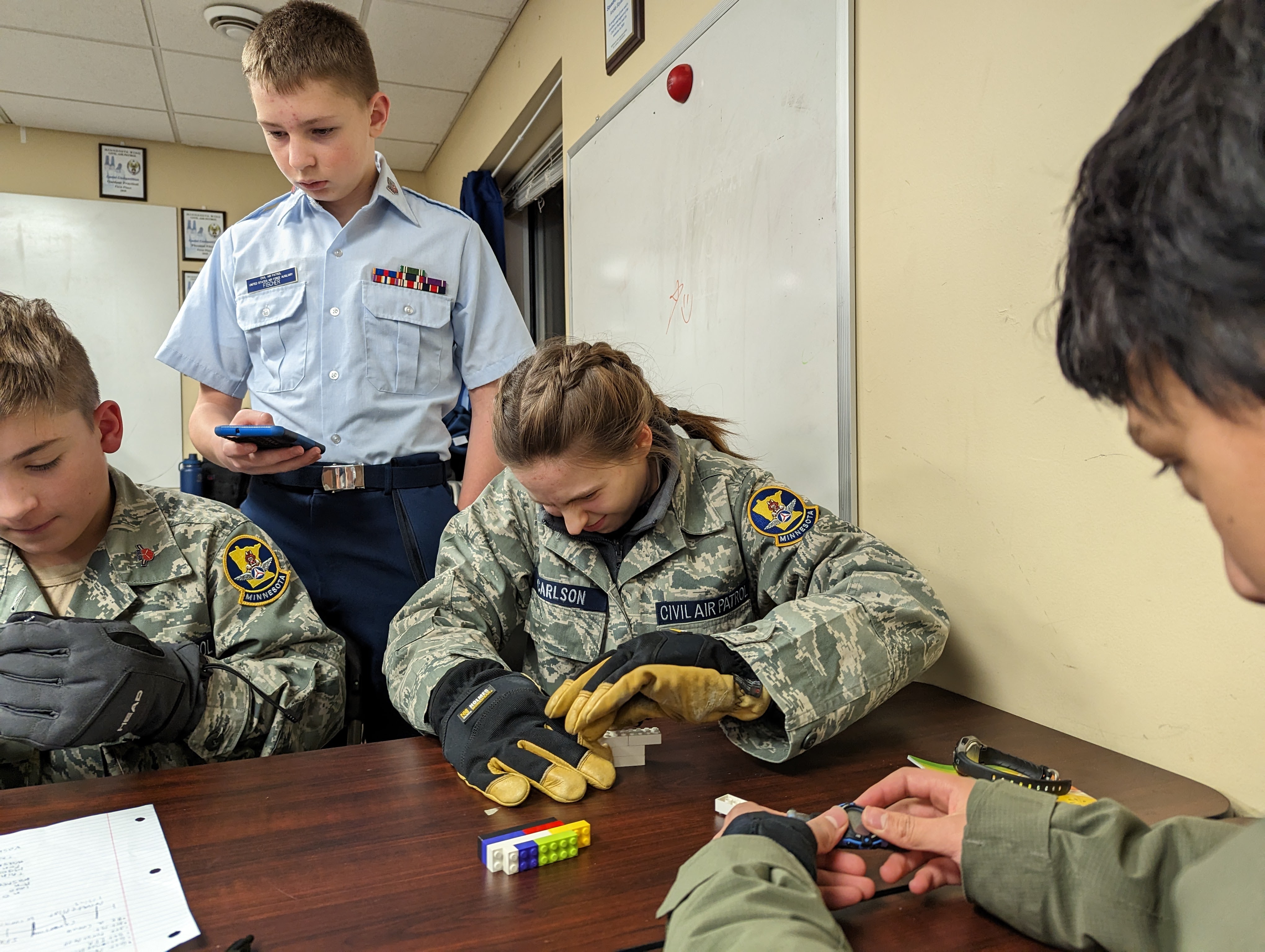 Squadron cadets work with legos while wearing work gloves