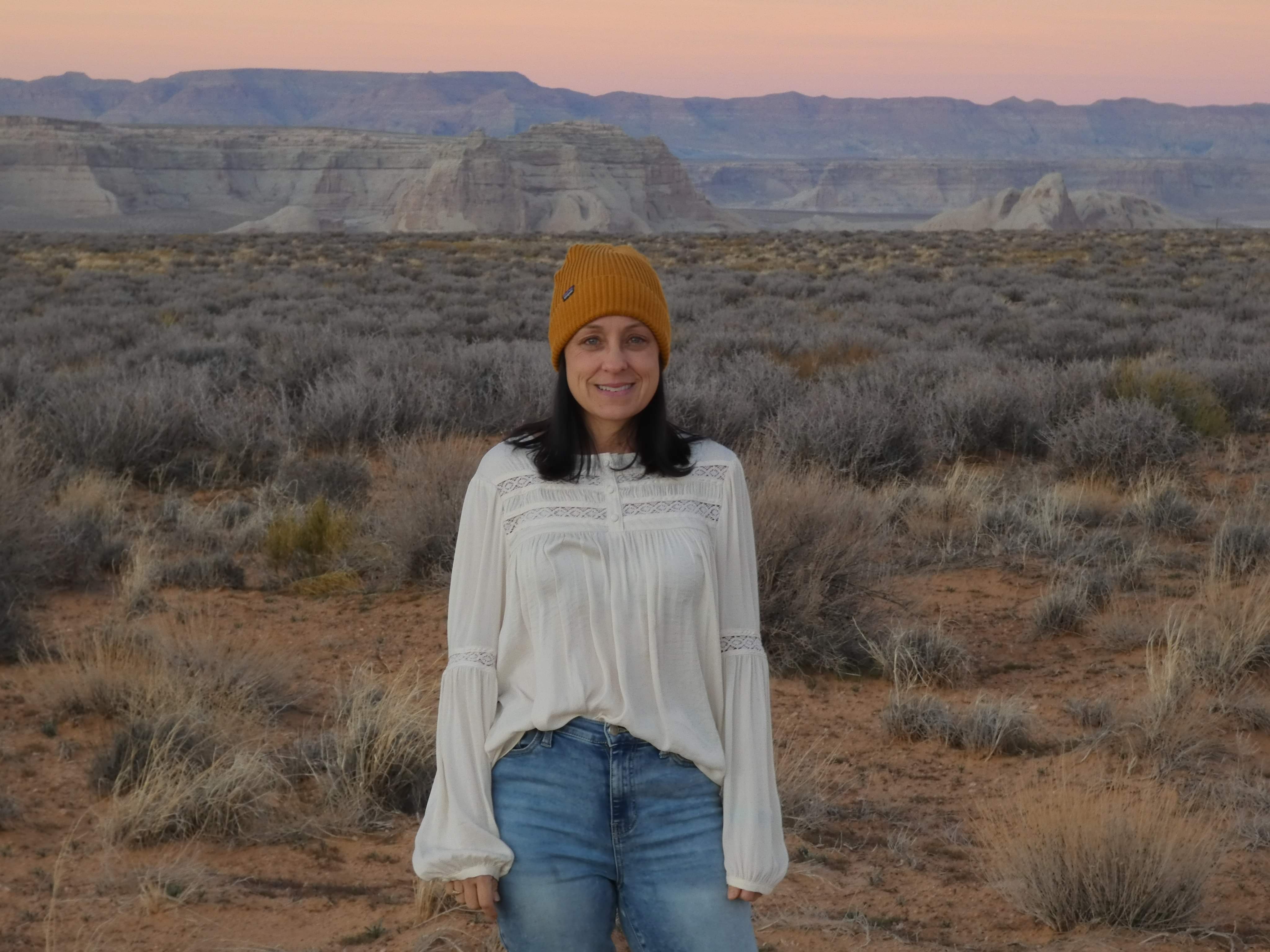 AEM Lisa Medlyn poses in front of scenic Arizona terrain on a hike.