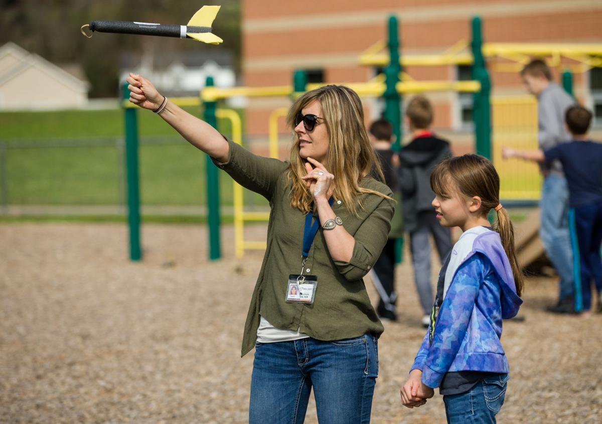 Meghan Salter works on rocket launch with student