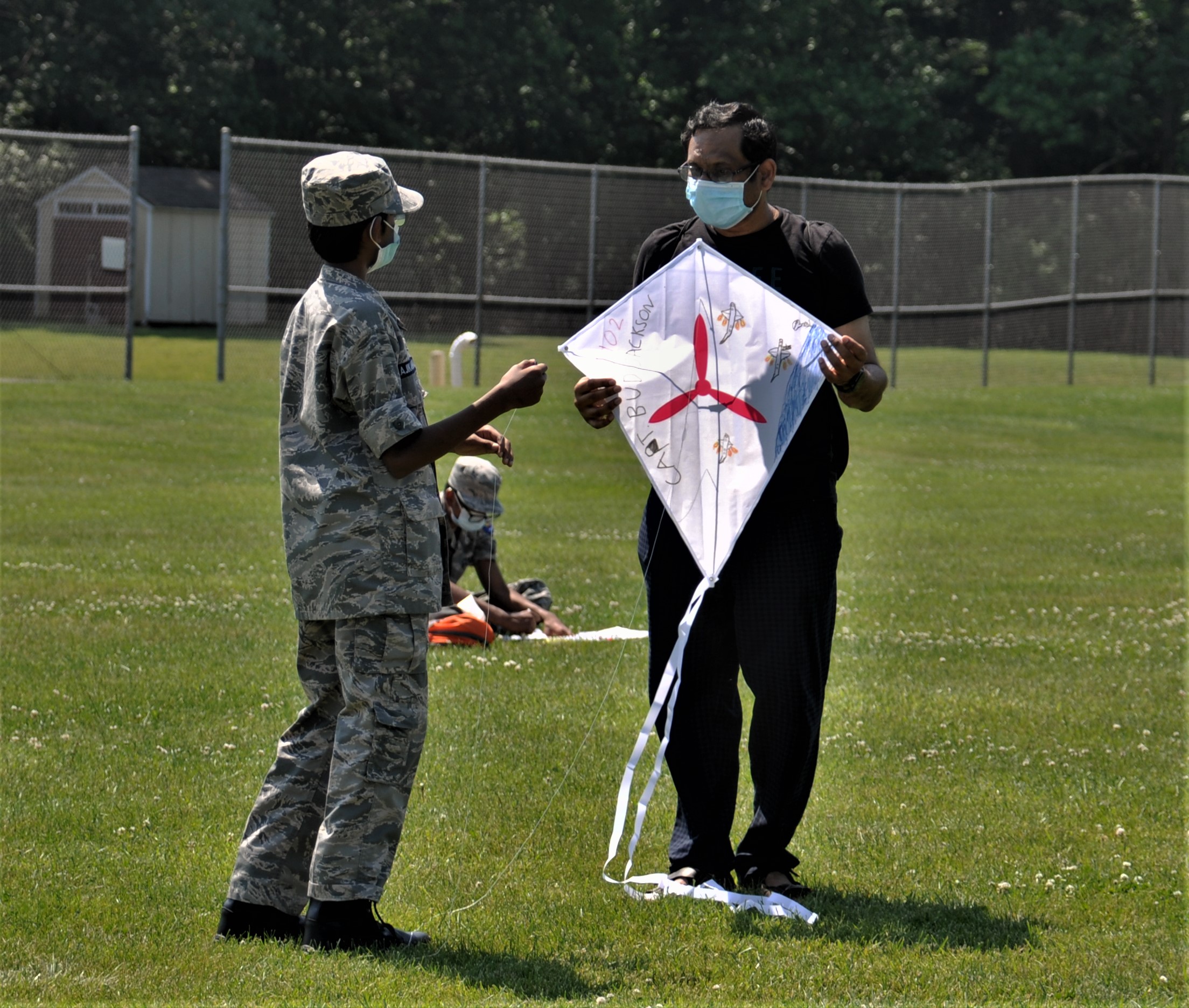 Cadet and leader prepare to fly a kite