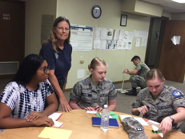 Lt. Col. Bonnie Hinck (Baldatti) works with cadets on an AE project